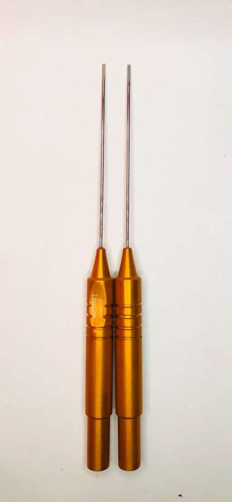 Two Taylor Liberator cannulas by Alpha Surgicals with orange anodized aluminum handles and thin metal cannula tips, placed vertically side by side on a white background
